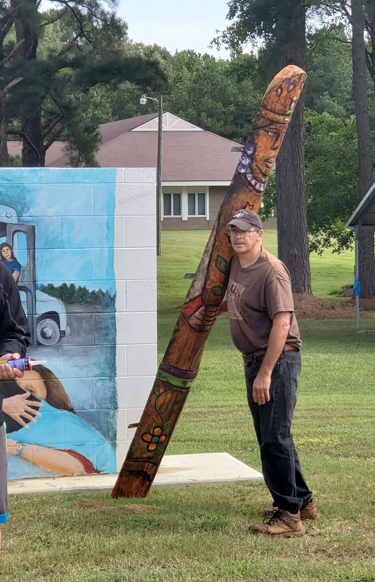  With the painting complete, artist Phillip Harley is ready to install the six sculptures along both sides of the mural wall.  Photo courtesy of Karen Harley  