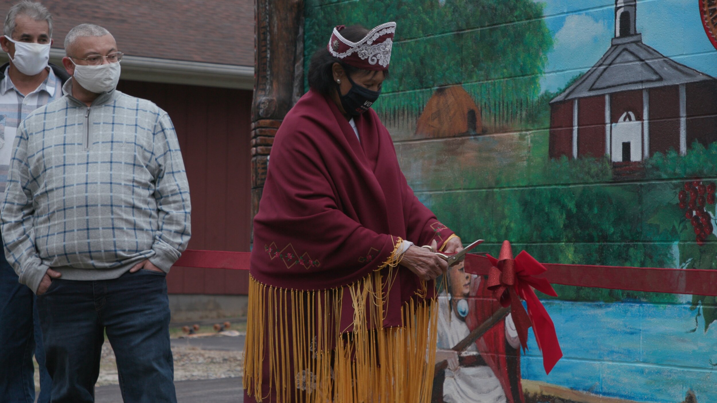  (L to R) Artist Phillip Harley and Project Manager Dr. Marvin “Marty” Richardson look on while Dr. Brucie Ogletree Green Richardson, Chief of the Haliwa-Saponi Indian Tribe, cuts the ribbon.  Photo Courtesy of Brooks Bennett  