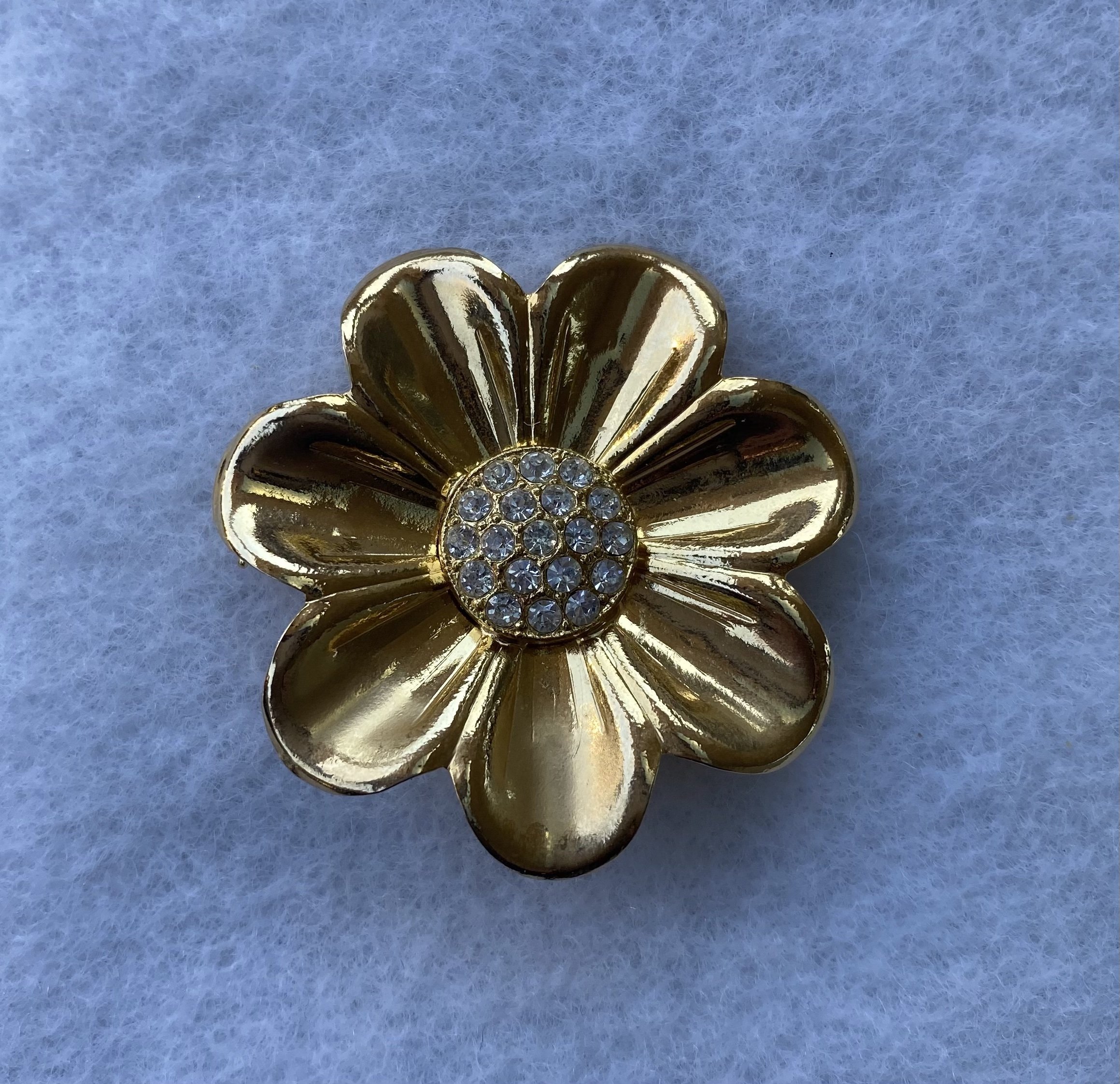 $10, gold flower with rhinestone center