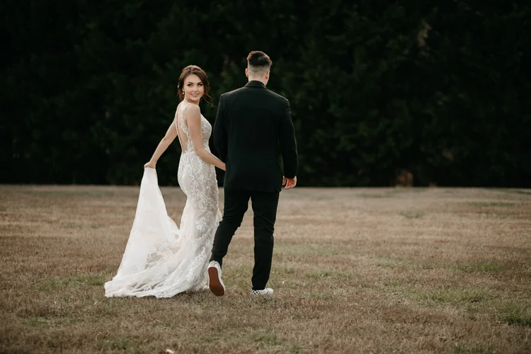 Bride and groom walking together, wedding photography by MYXD MEDIA