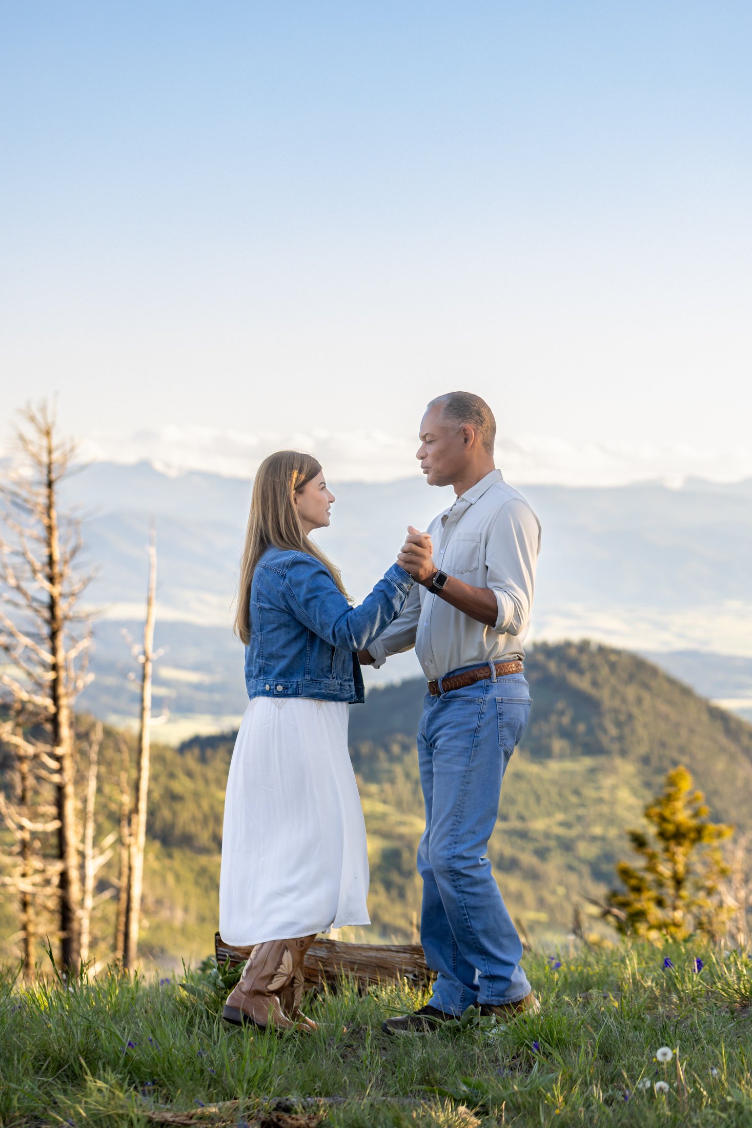 A couple uses their Montana Engagement session to practice their wedding dance as they are surrounded by the beauty of the mountains and the big sky.