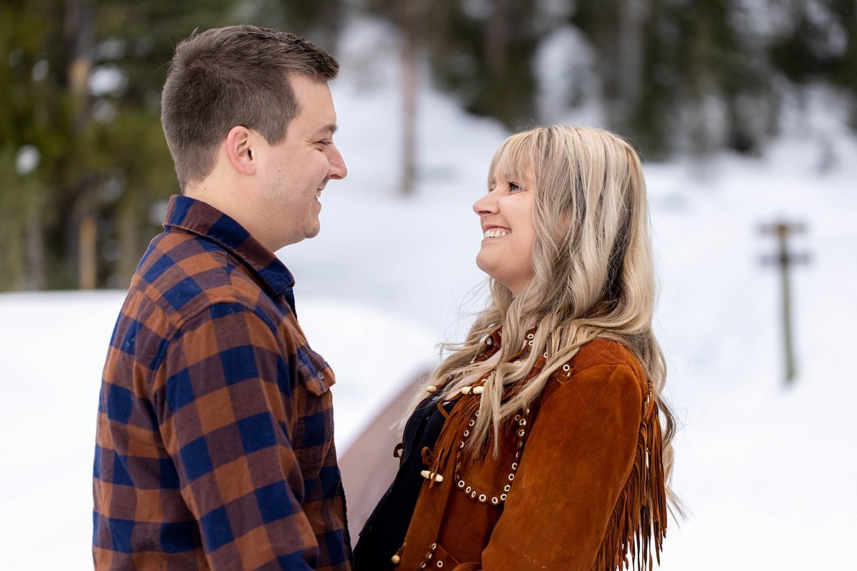 Couple making eye contact during engagement session, with very natural smiles.