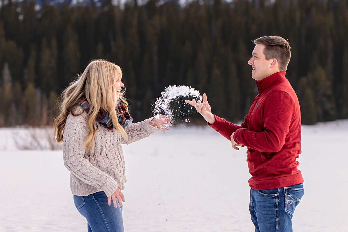 Aman is tossing snow at his bride to be, gentle but  both are laughing.