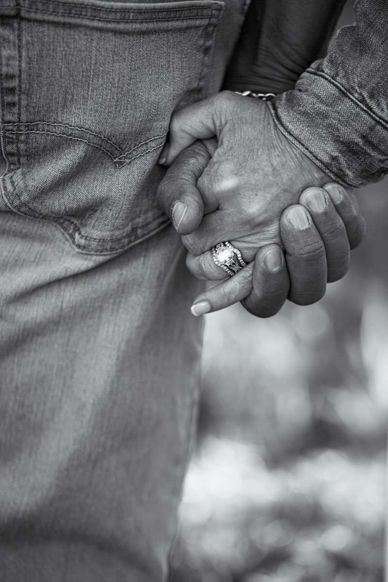 This black and white image poignantly shows the love of a couple by focusing in on their hands held tight and close to their bodies - connecting them physically and emotionally. That is what Montana Engagement Sessions are about!