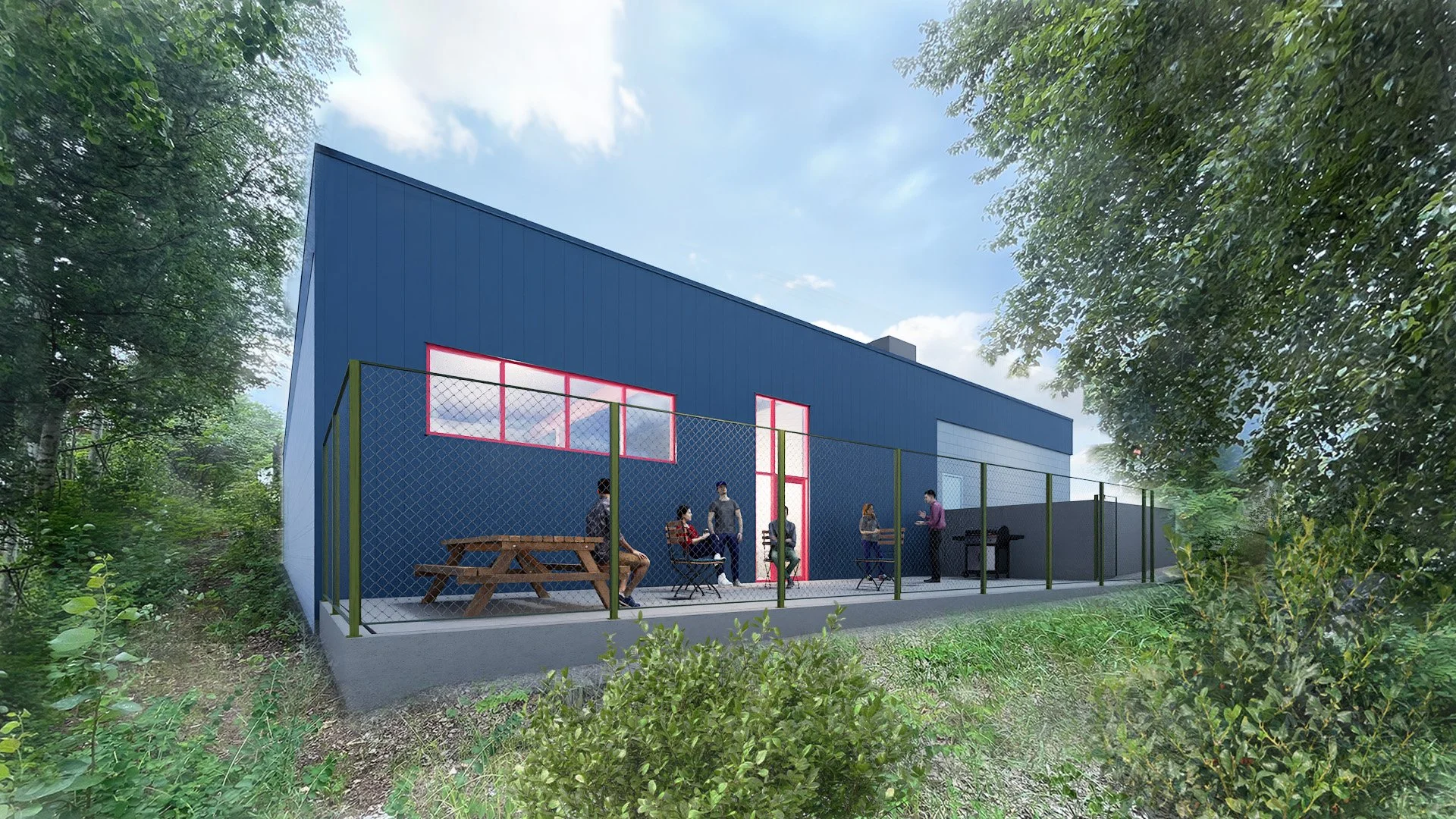 A modern building with a blue exterior, large pink-framed windows, and a fenced patio area with several people gathered, some sitting and some standing, surrounded by greenery.