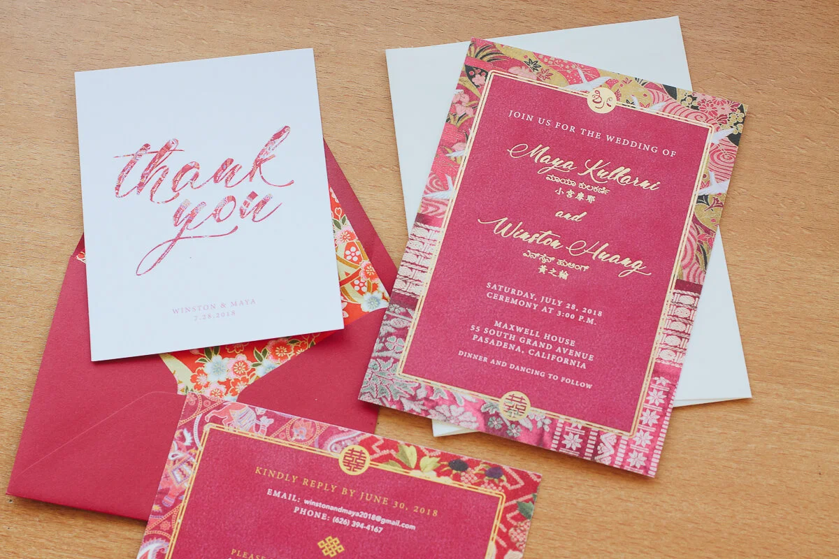 image description: flat lay of Maya’s wedding stationary (that she designed). includes an invitation, RSVP card, thank you card and envelope.