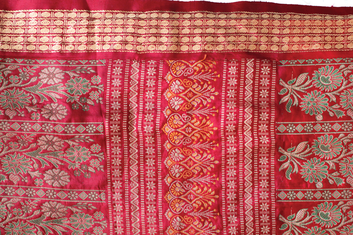 image description: a photo I took of a red sari I owned. I later used this photo in the background of the invitation.