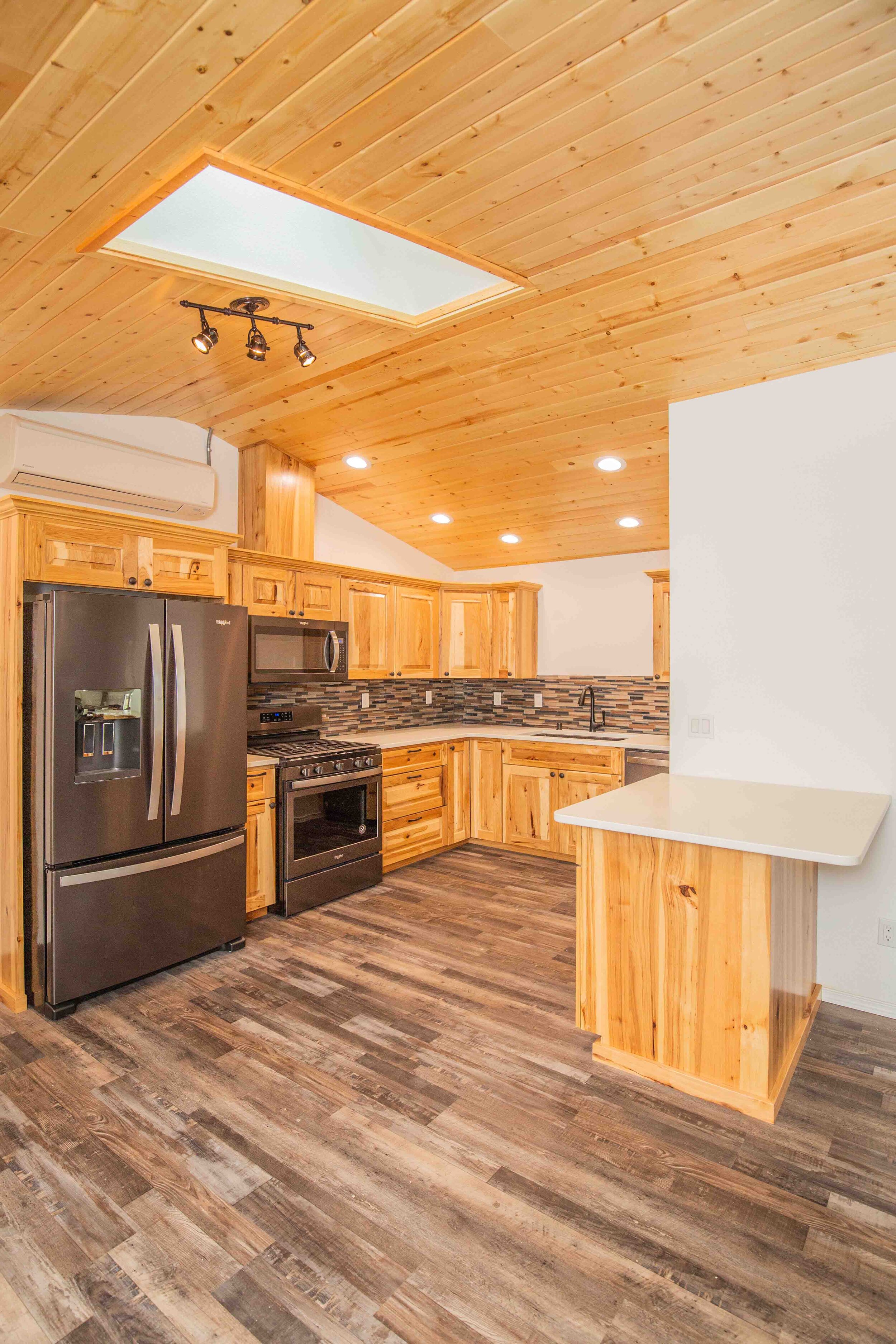 24ResTech's experienced team developed a plan to expand the kitchen's storage by adding cabinetry, developing a better kitchen layout, and adding a peninsula for increased dining space.