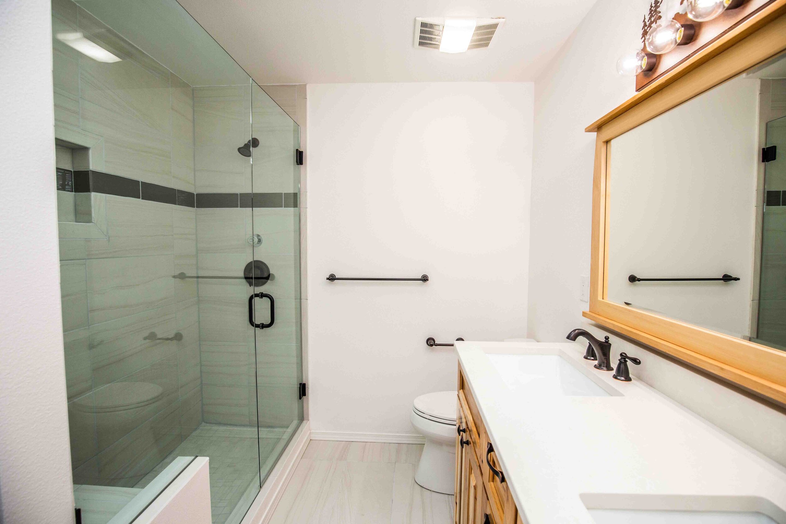 The scope included a large primary ensuite restoration, incorporating the cabin-style aesthetics.