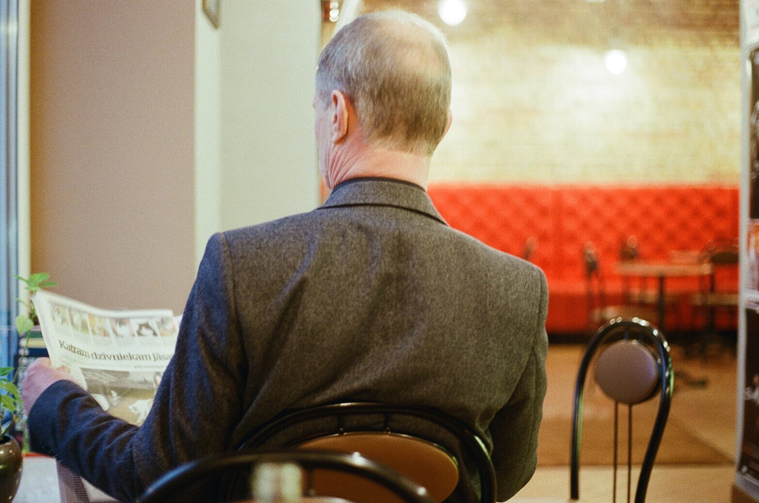 Man reading paper cafe 2.jpg