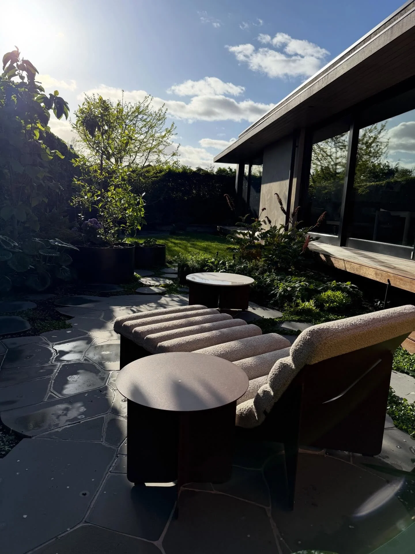 Sunlight, texture and a touch of green&hellip;The perfect spot for your morning coffee or evening vino 🍷 

This rear garden brings together lush planting, natural bluestone and soft furnishings to create a private sanctuary

Designer: @mudoffice 
Fu