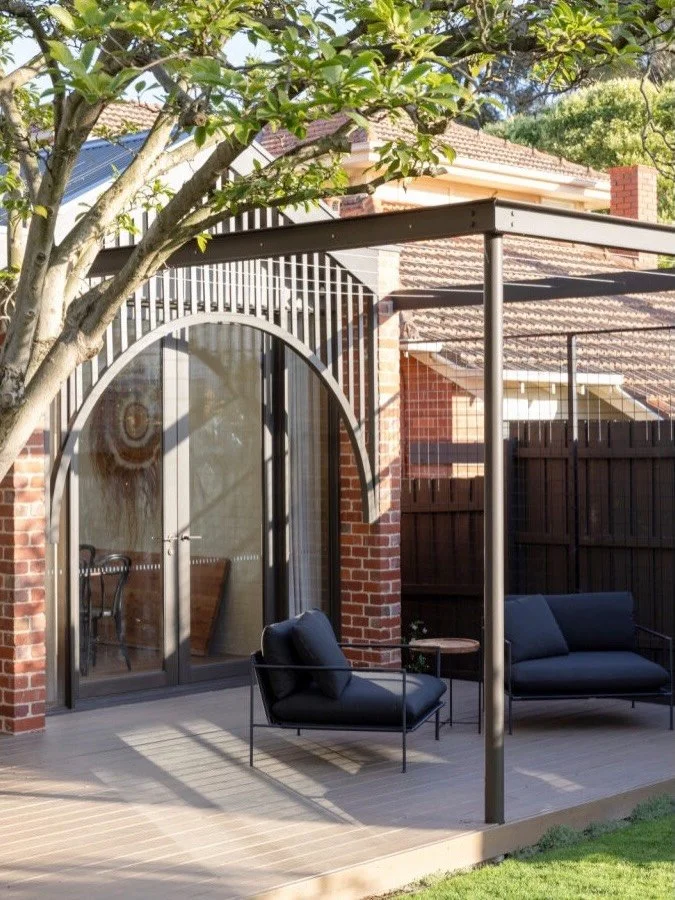 The kind of view that makes you sit a little longer 🌳

Beneath the canopy of a grand Magnolia this quiet seating area invites rest and relaxation. We live how the curved granite path creates a calm connection between architecture and the landscape 
