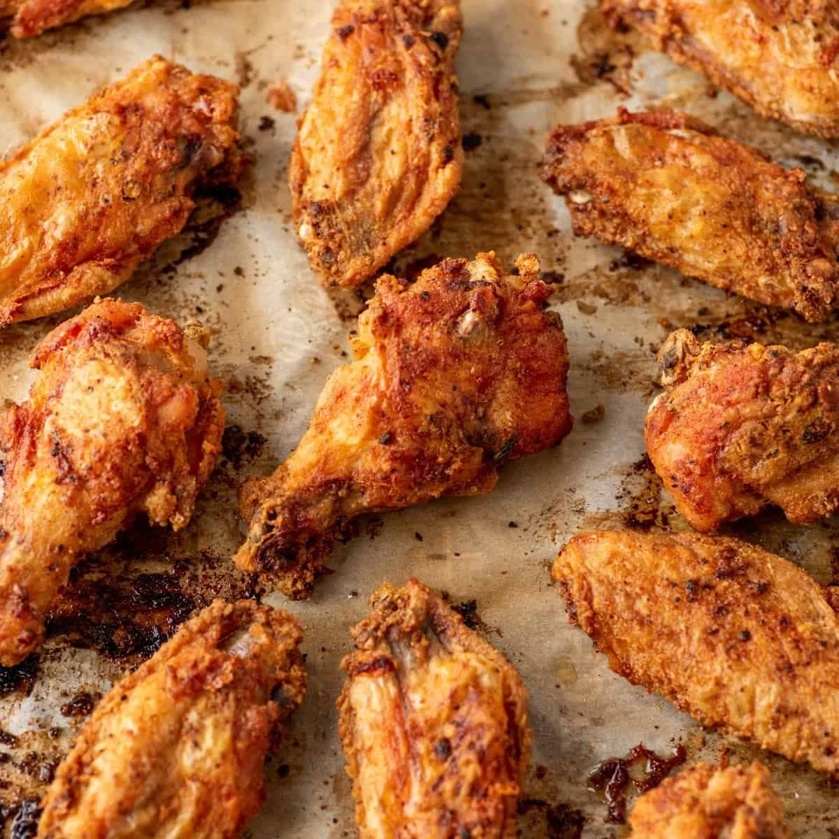 Crispy-Baked-Chicken-Wings-Close-up-on-Parchment-Paper-square.jpg
