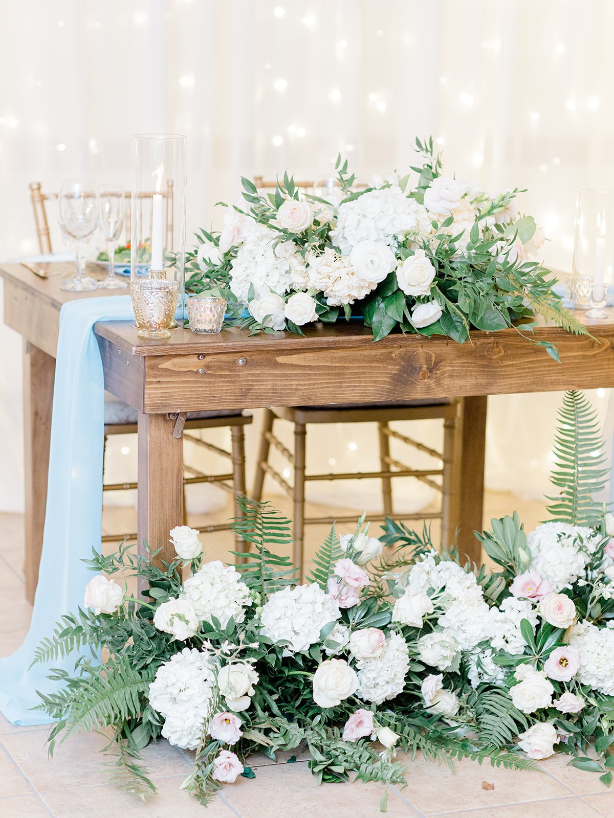 Hallie and Patrick sweetheart table with back draping.jpg