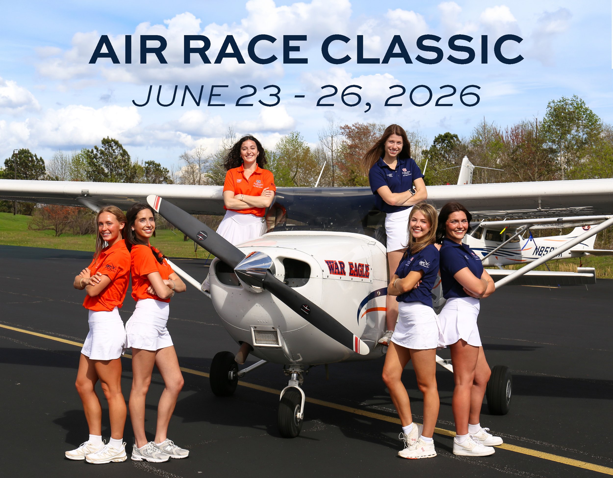 A group photo of six female pilots in either orange or blue polos, smile up at the camera. Text above them reads "Air Race Classic, June 23 - 26, 2026."