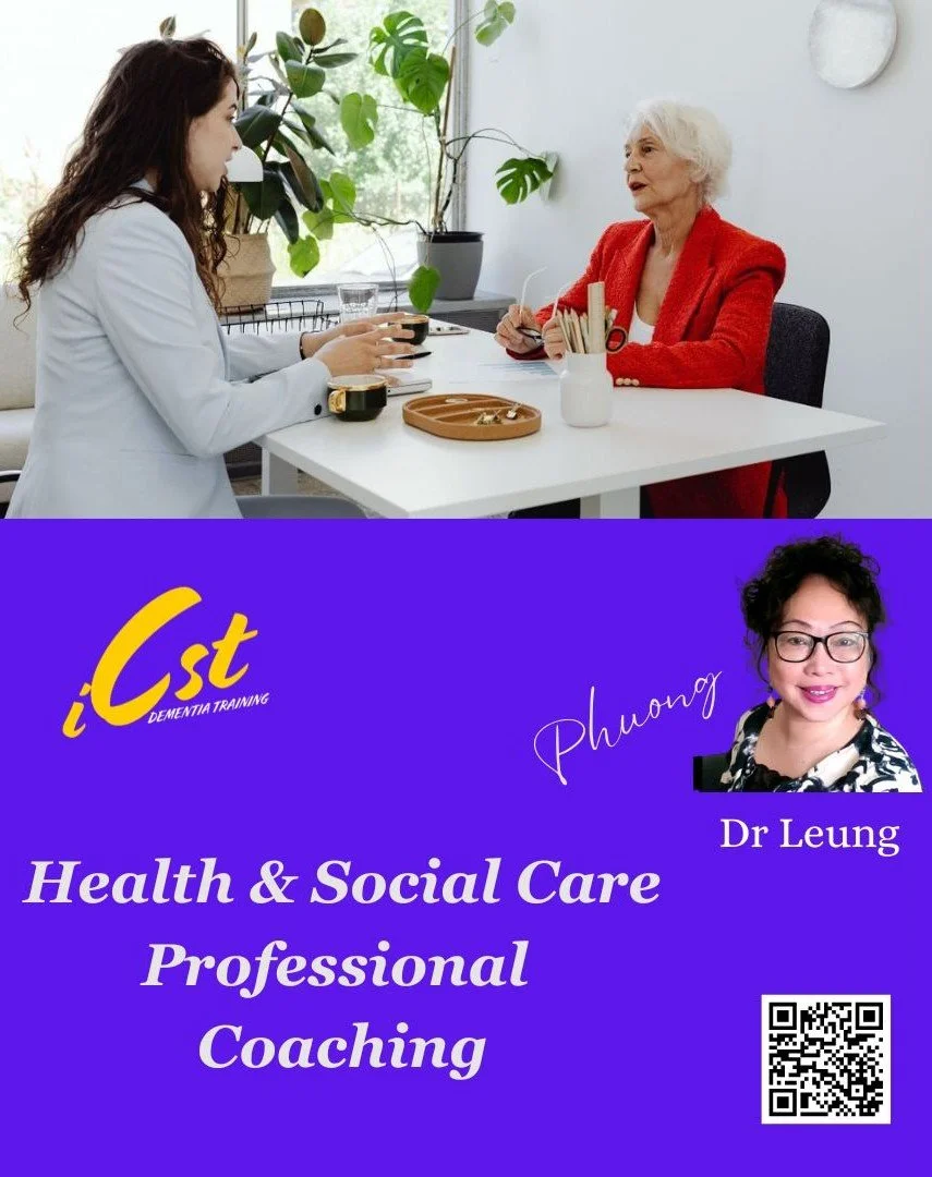 A young woman in a white coat talking to an elderly woman with white hair, sitting at a white table with plants in the background.