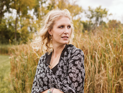 Anne Campbell in a field of wild grasses