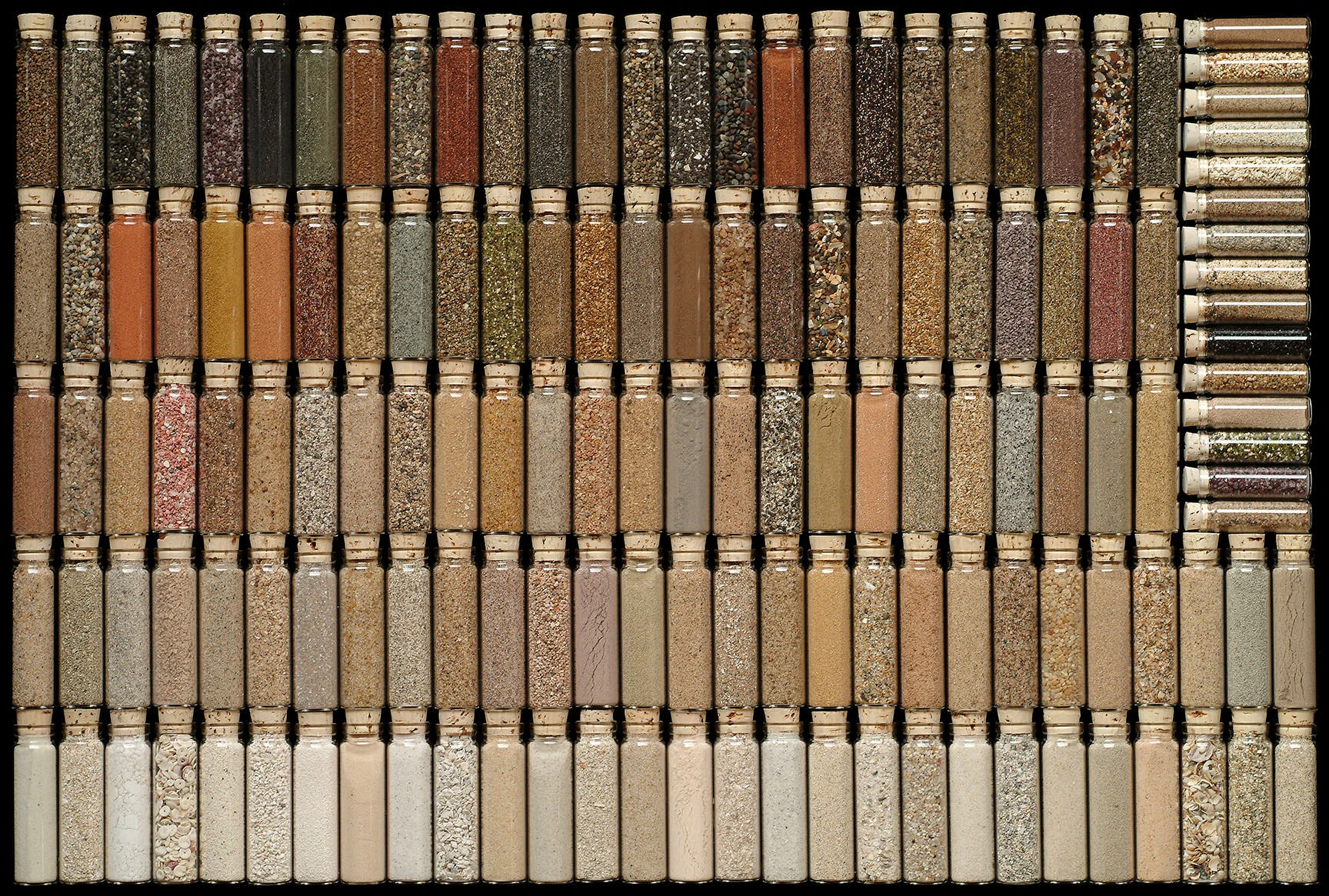 Sands from around the world, contributed by friends and other sand collectors. Each vial is about 4” tall and is labeled with the geographical location. I array them by color and texture, not by geography. Tiny vials are from more “exotic” places, where I could only obtain a small sample.