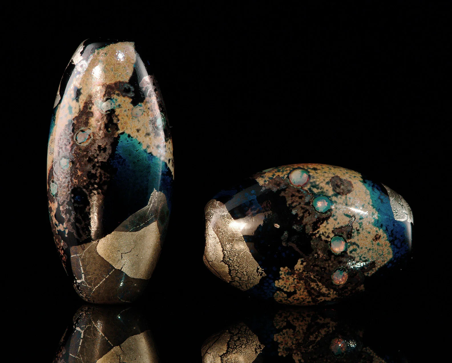 “Black Lagoon Beads” oval lenticular shapes with silver and gold colorants, tallest bead about 4 cm. 2001.