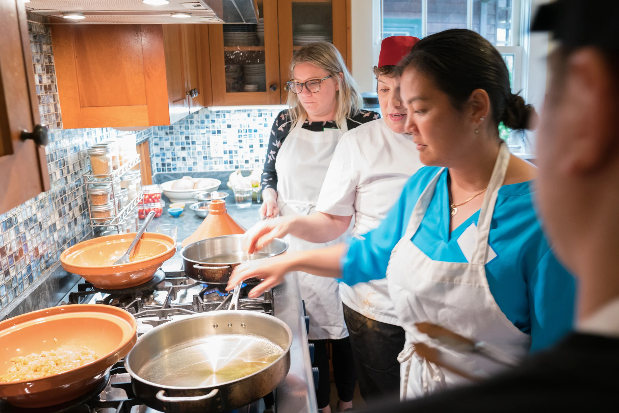 Cook-with-Chef-Traci-team-building-heating-oil-for-making-tagine.jpg