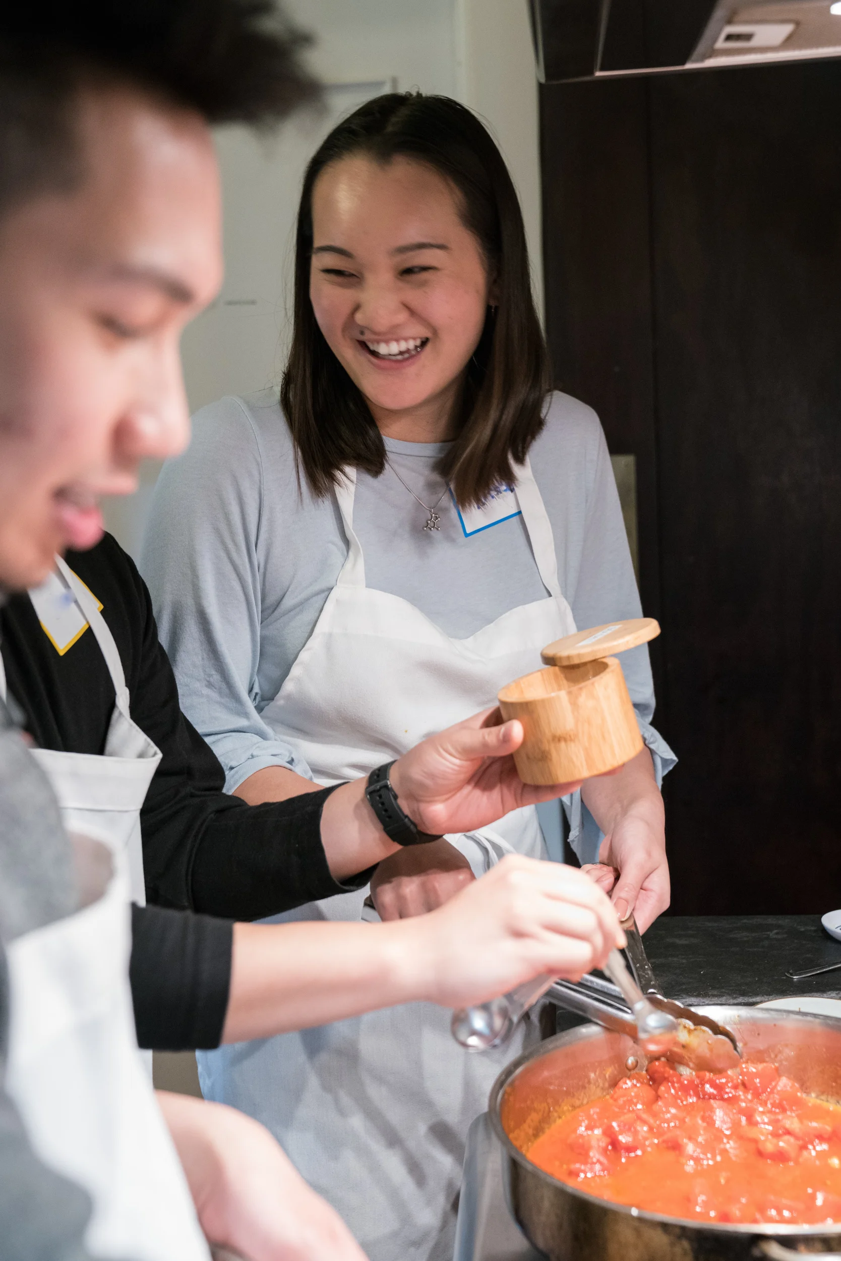 Cook-with-Chef-Traci-team-building-man-and woman-cooking-tomatoes-vertical.jpg