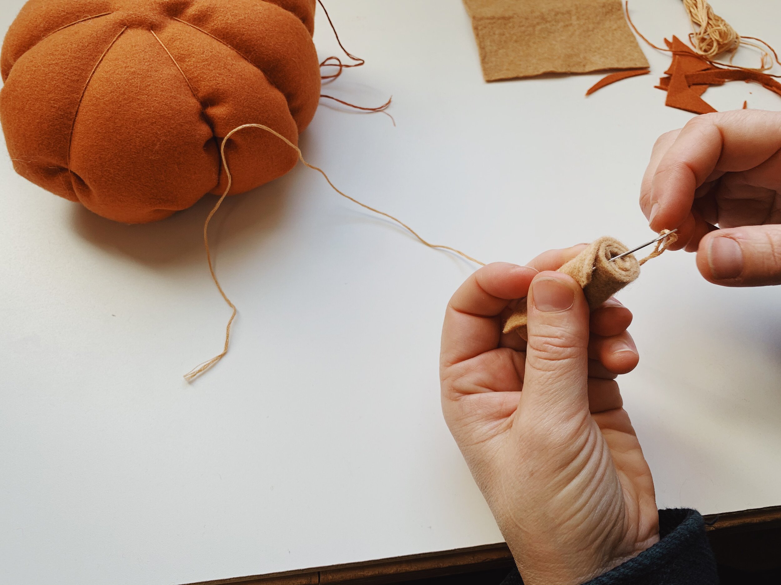 Use blanket stitch to secure the rolled edge of felt to the stem