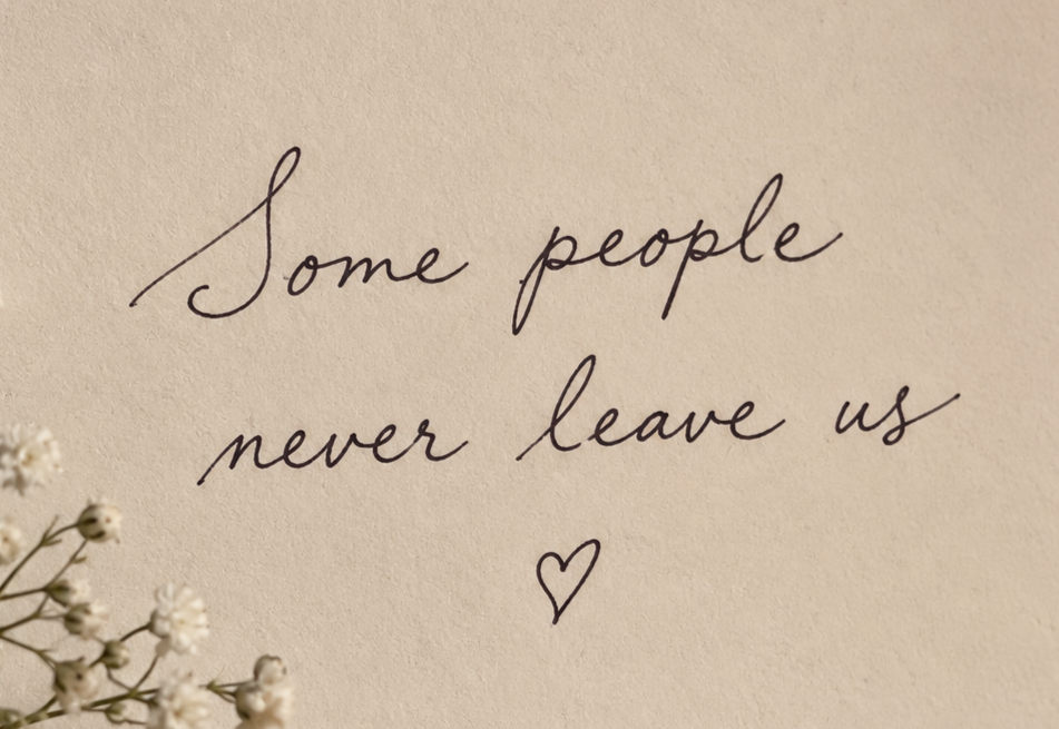 A handwritten note on beige paper that says, 'Some people never leave us,' accompanied by a small heart drawing and some white flowers in the corner.