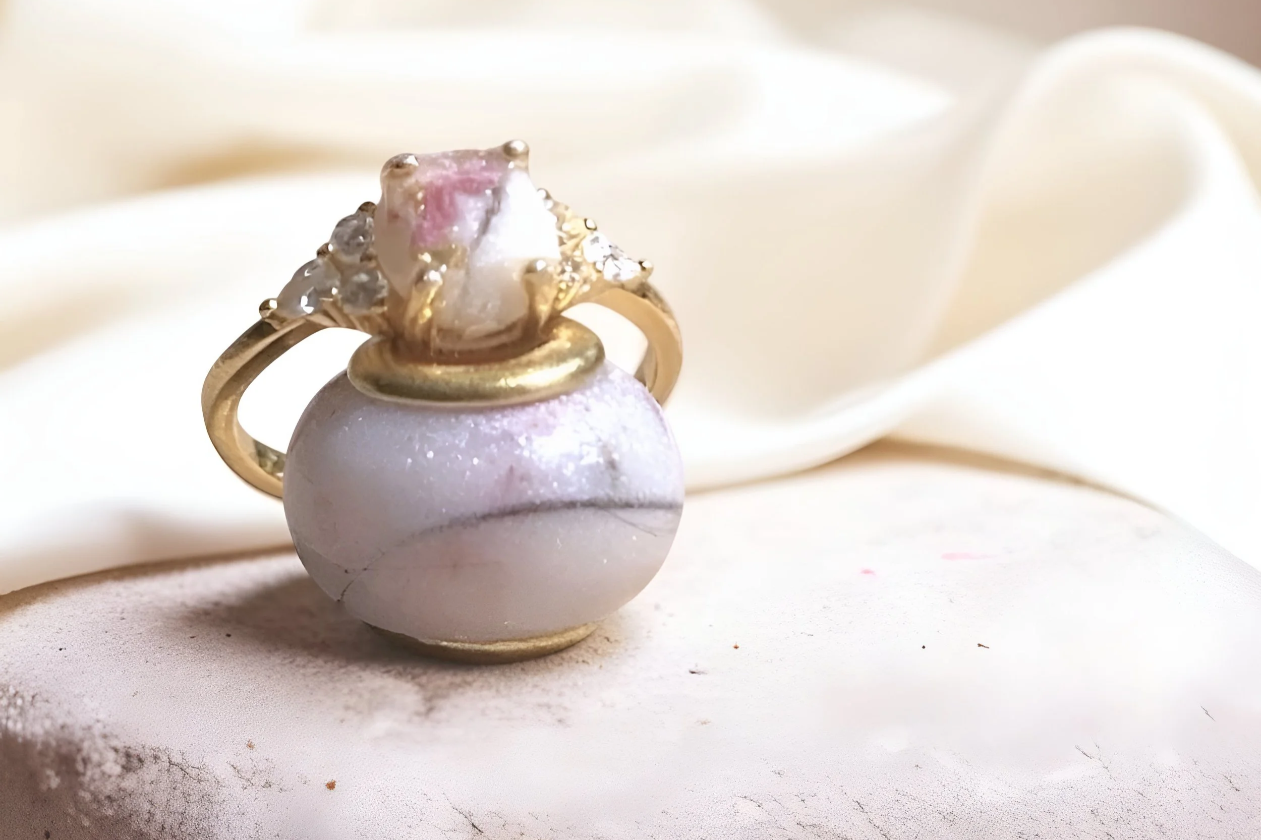 Gold memorial ring with a pink gemstone.