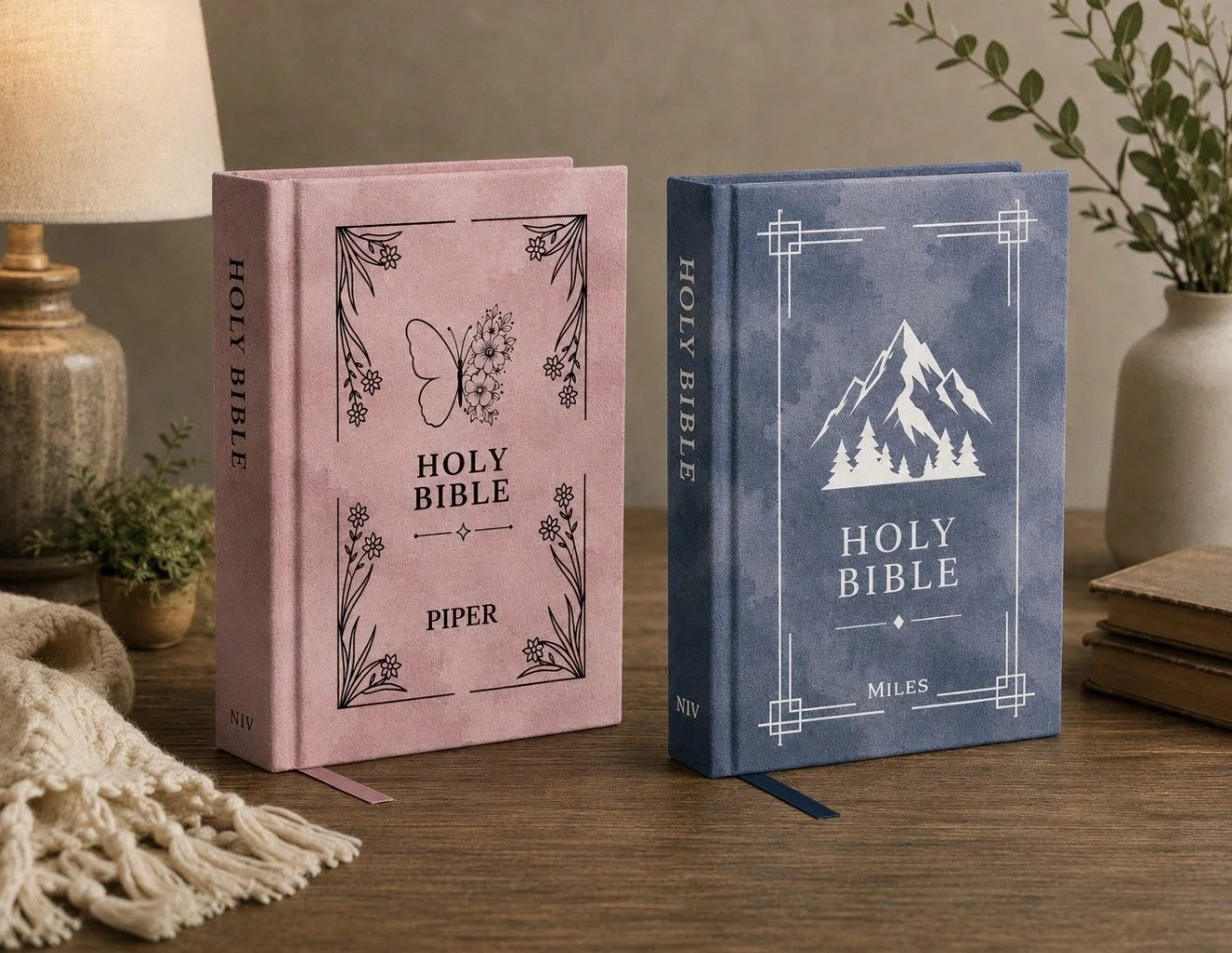 Two personalized Holy Bibles with floral and mountain cover designs.