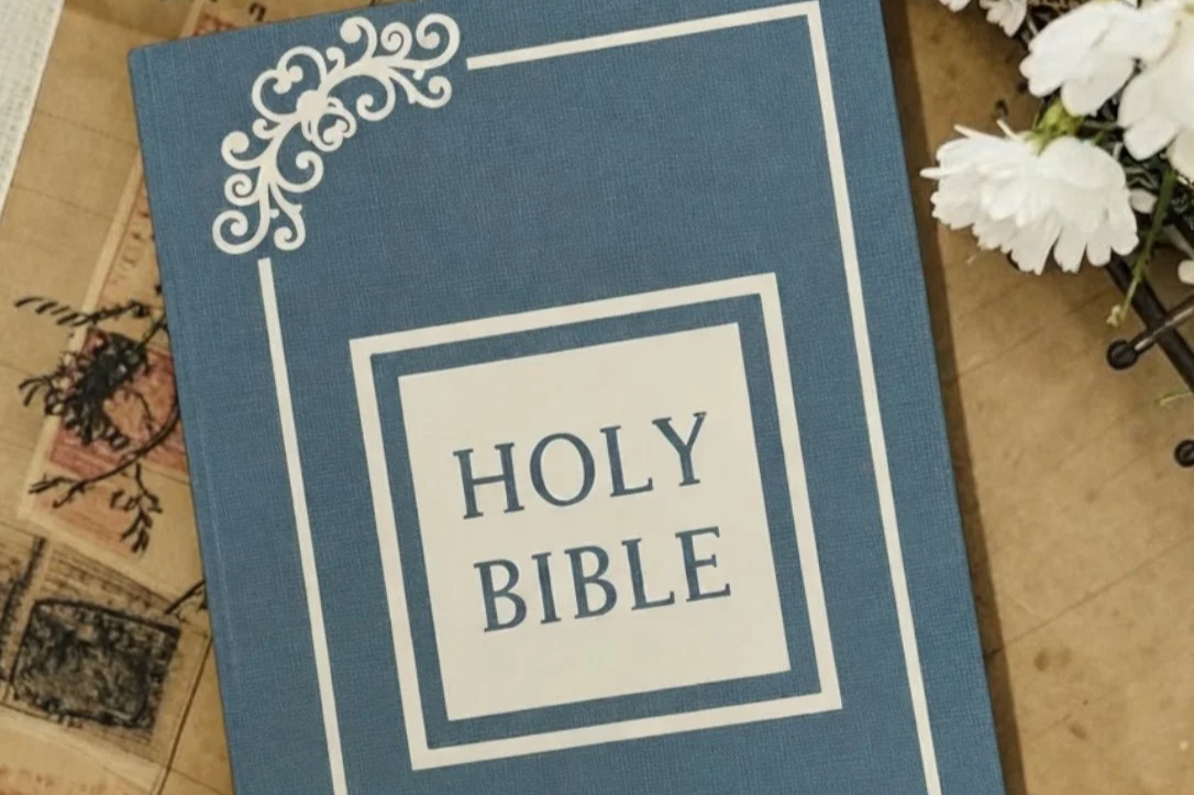 Blue personalized Holy Bible with ornate white cover design.