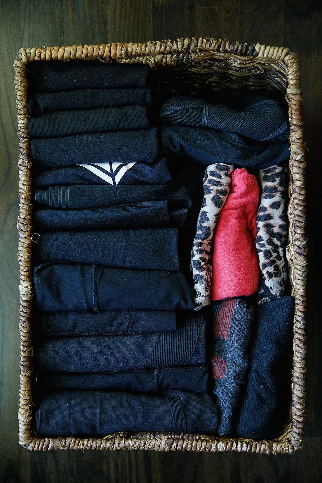 A woven basket holds folded clothes
