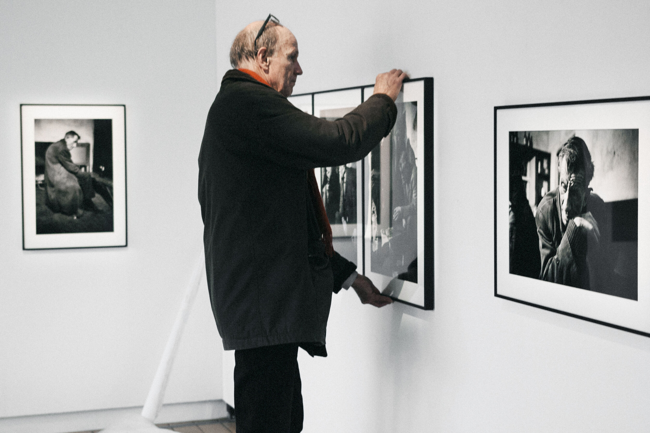  Artist Krass Clement putting up a photograph in his exhibition 'The Light Gleams An Instant’ 