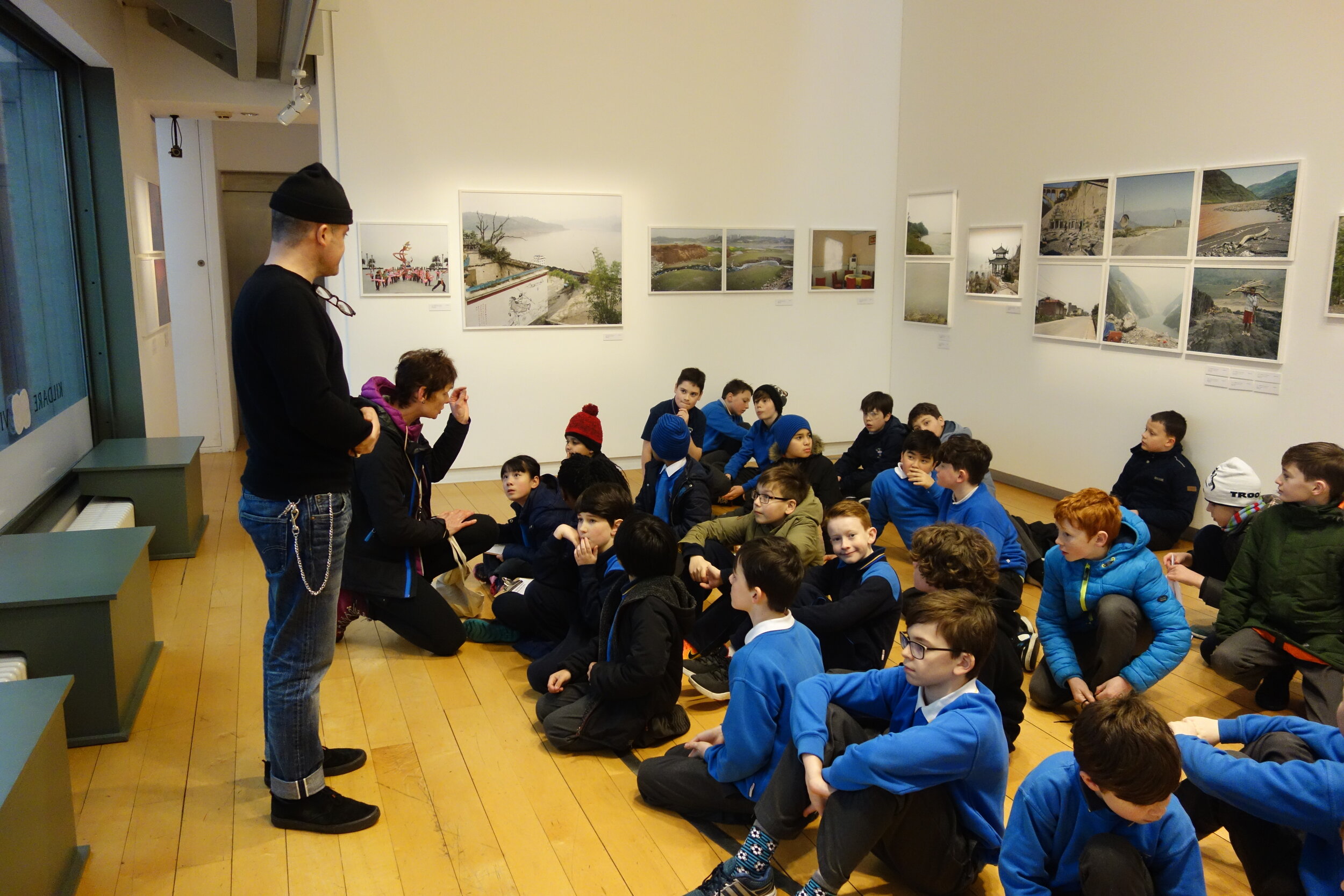  Communications Manager Darragh Shanahan giving a tour of the exhibition to school pupils  