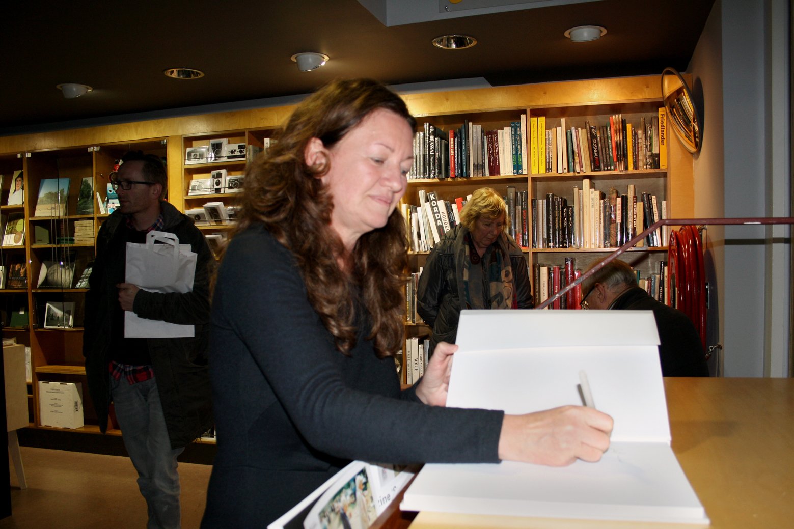 Photographer Jackie Nickerson signing a copy of her book 'Terrain'