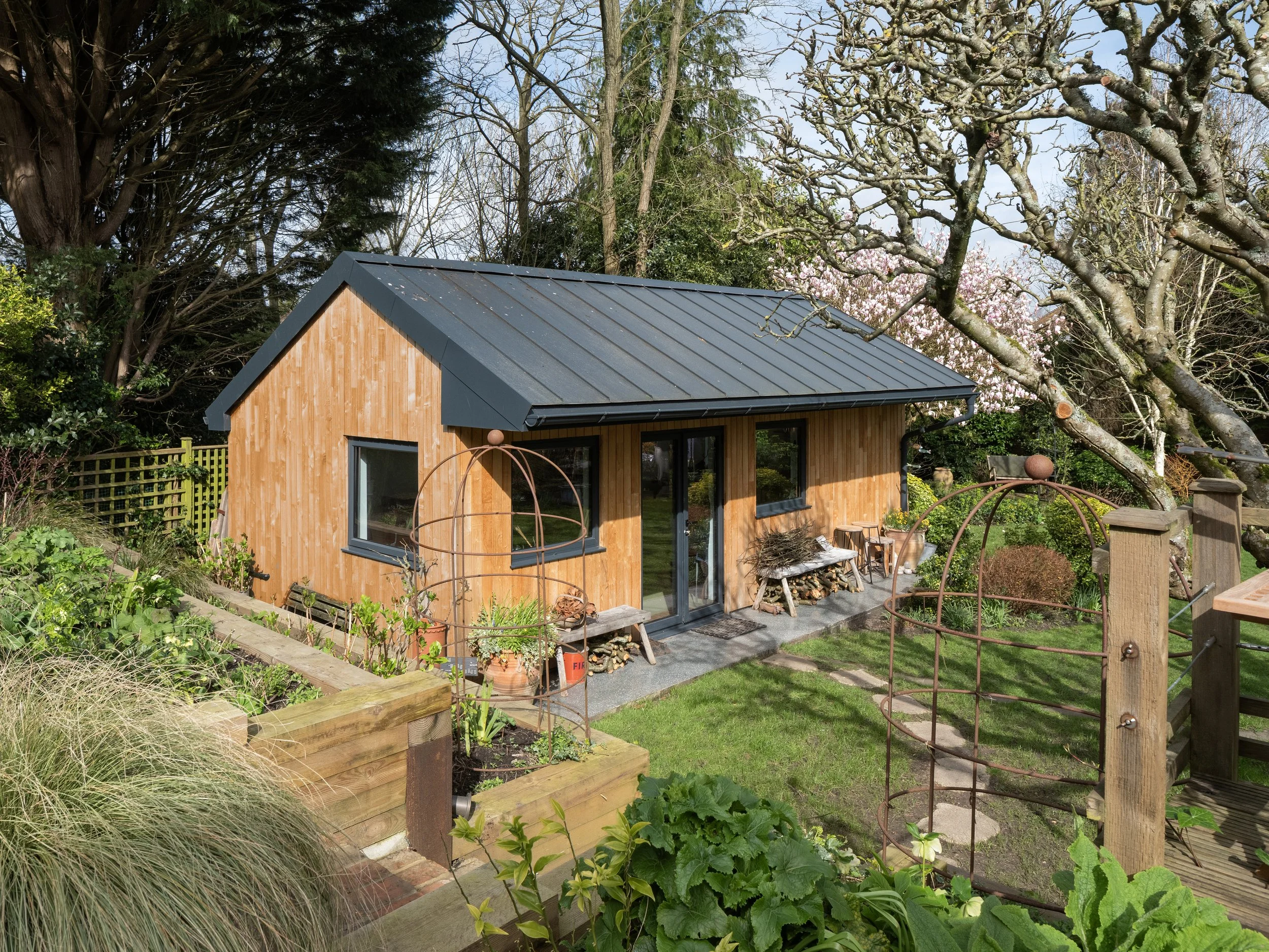 The Ugly Barn pottery studio in Ditchling, surrounded by greenery and trees in the South Downs countryside.