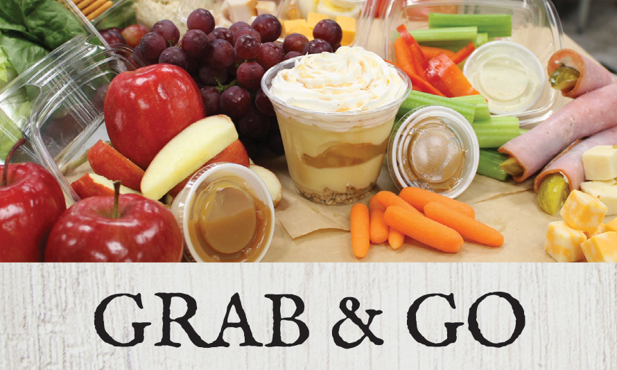 A variety of fresh fruits, vegetables, cheeses, and dips arranged for a grab-and-go meal.