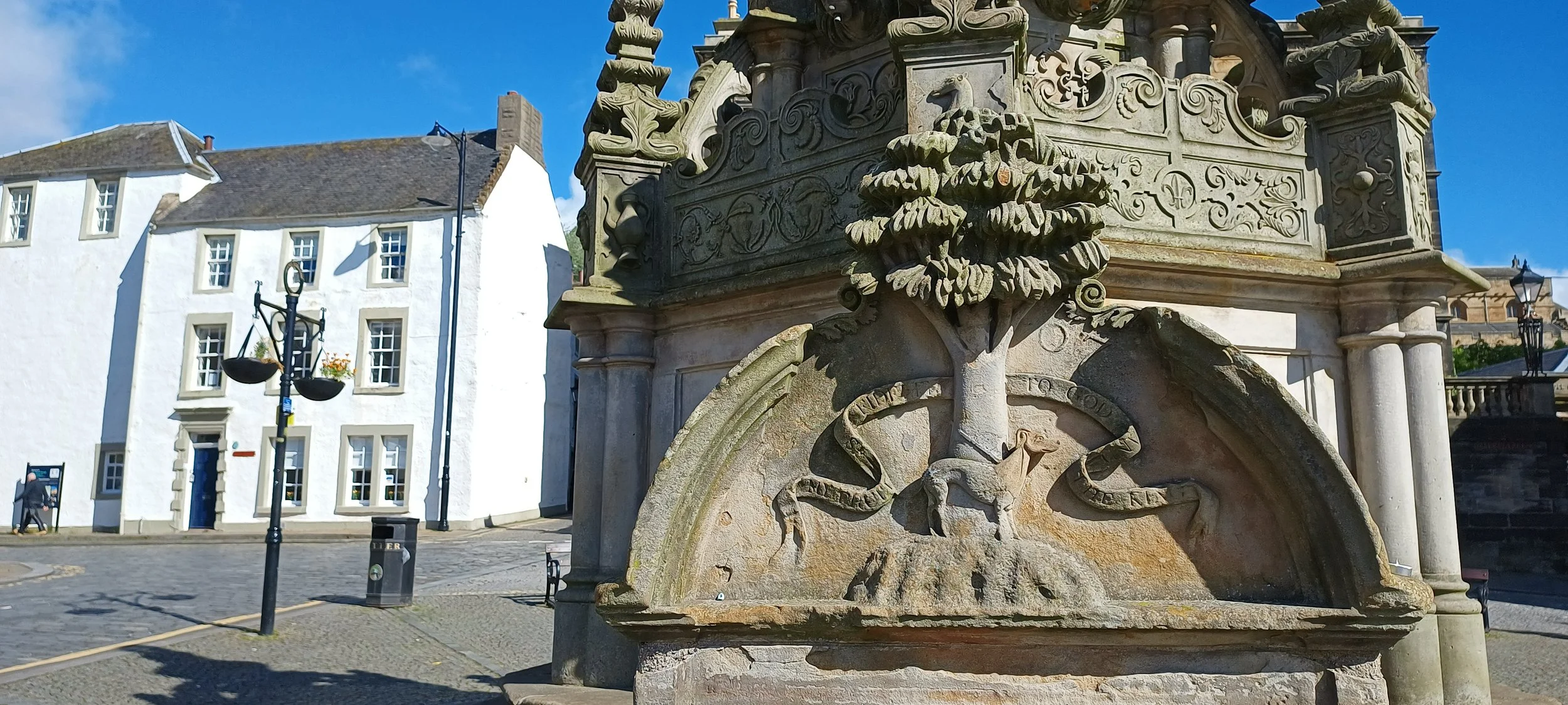 A carving of the legend of the Black Bitch on Linlithgow's Cross Well