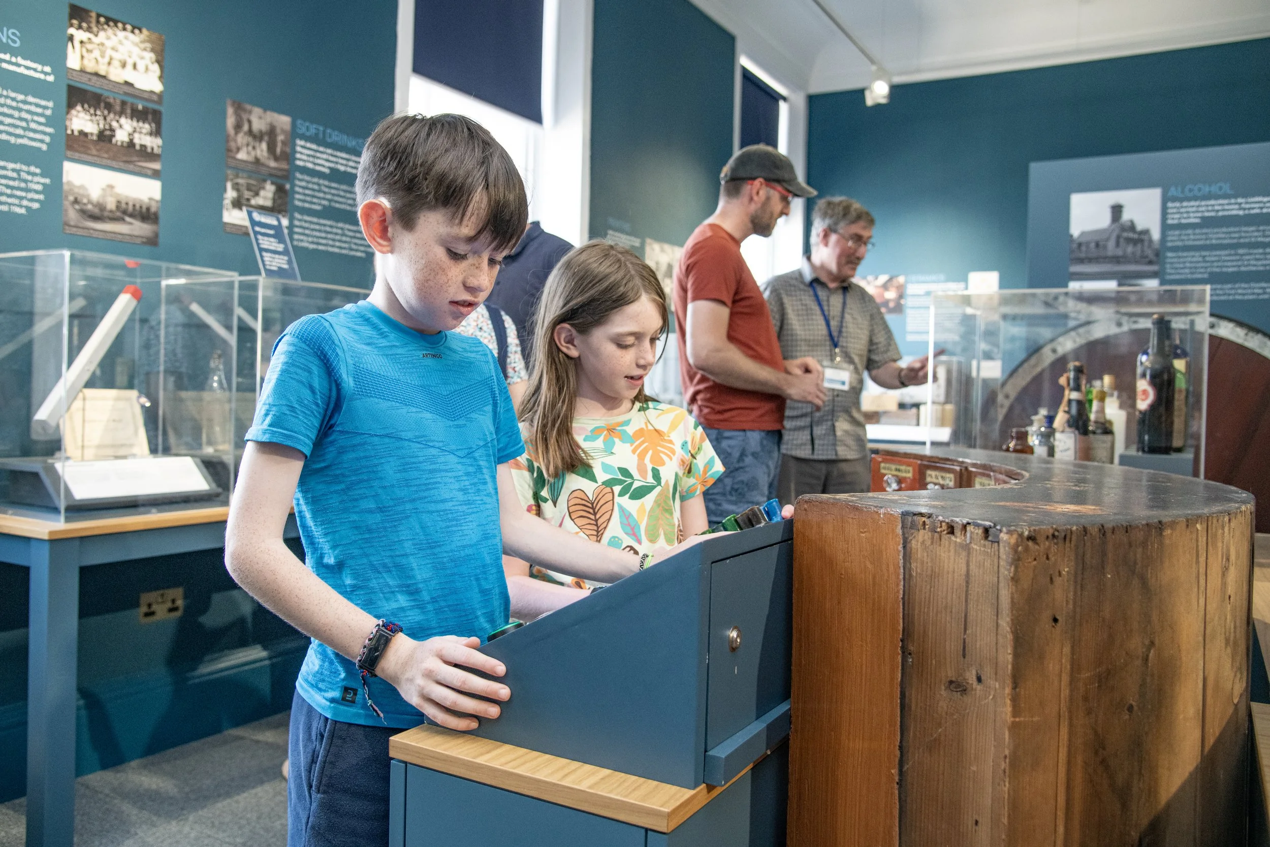 Two children playing with the museum's medicine interactive