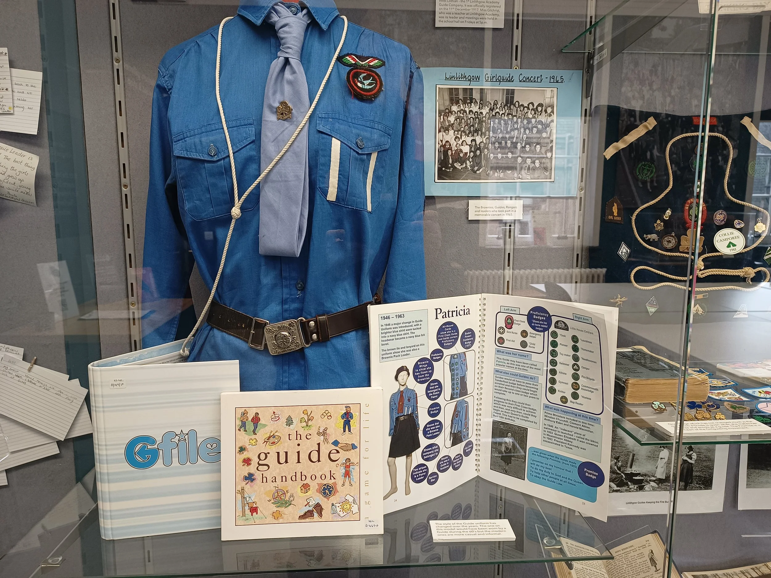 Girlguiding uniform, photographs and memorabilia displayed as part of a community exhibition at Linlithgow Museum.