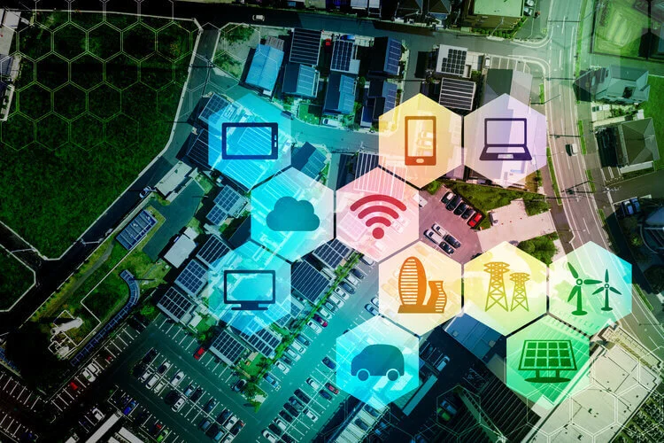 Overhead photograph of a housing development with icons overlaid of connected IOT devices