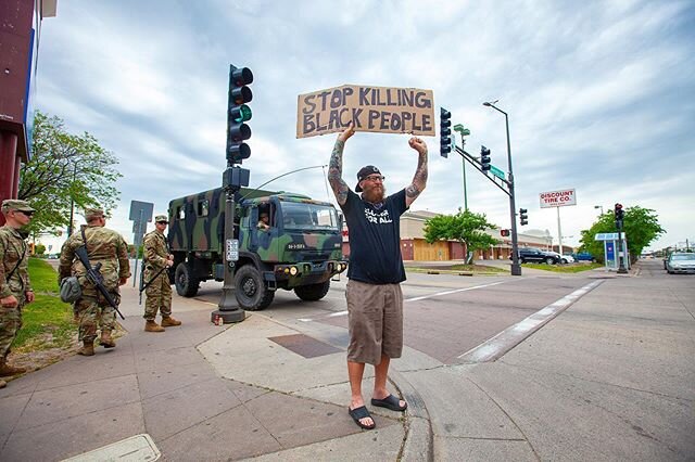 June 2, 2020 on University Avenue West in St. Paul protests continued near Target between Lexington and Snelling Avenues with a military presence on several corners. @notyourteacher651 stands on the corner of University Ave West with a message near T
