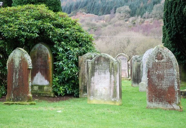 Weathered old gravestones in a cemetery