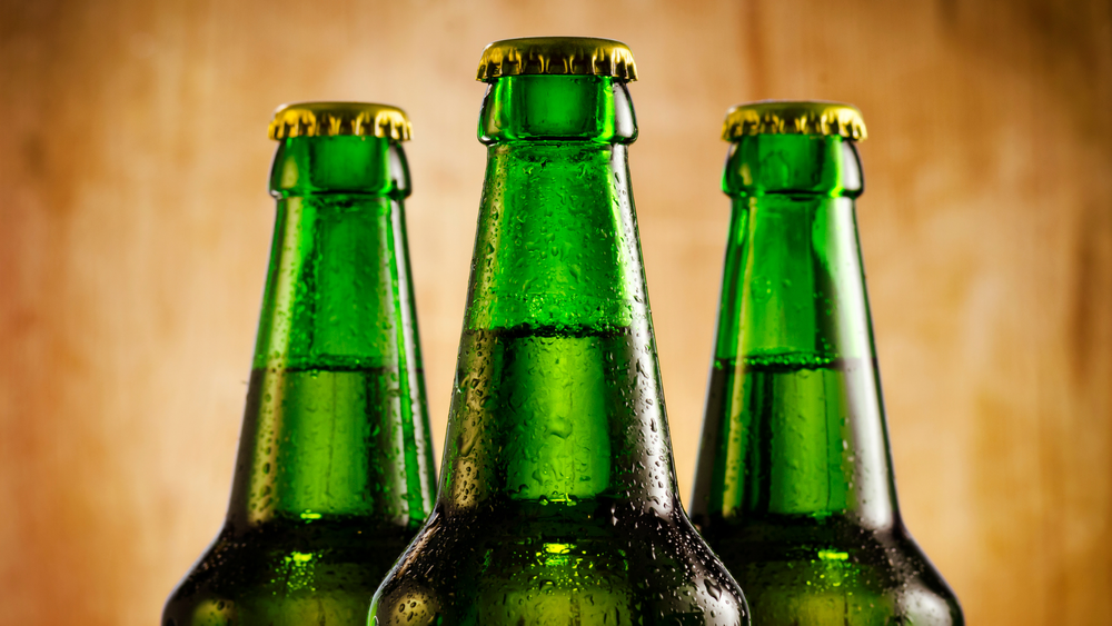 Three cold glass bottles with condensation