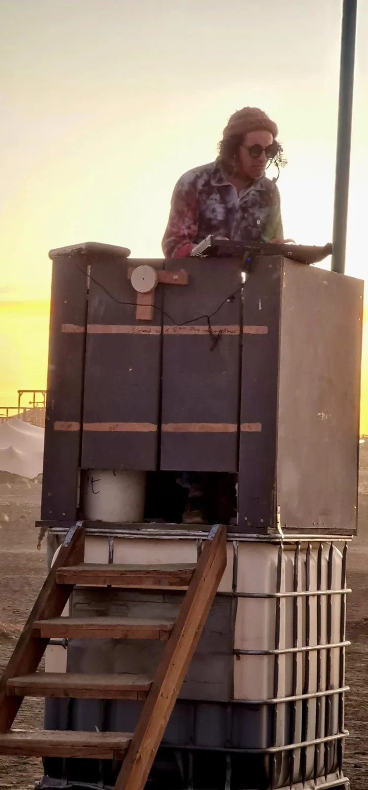  performing on the latrines at Afrika Burn 