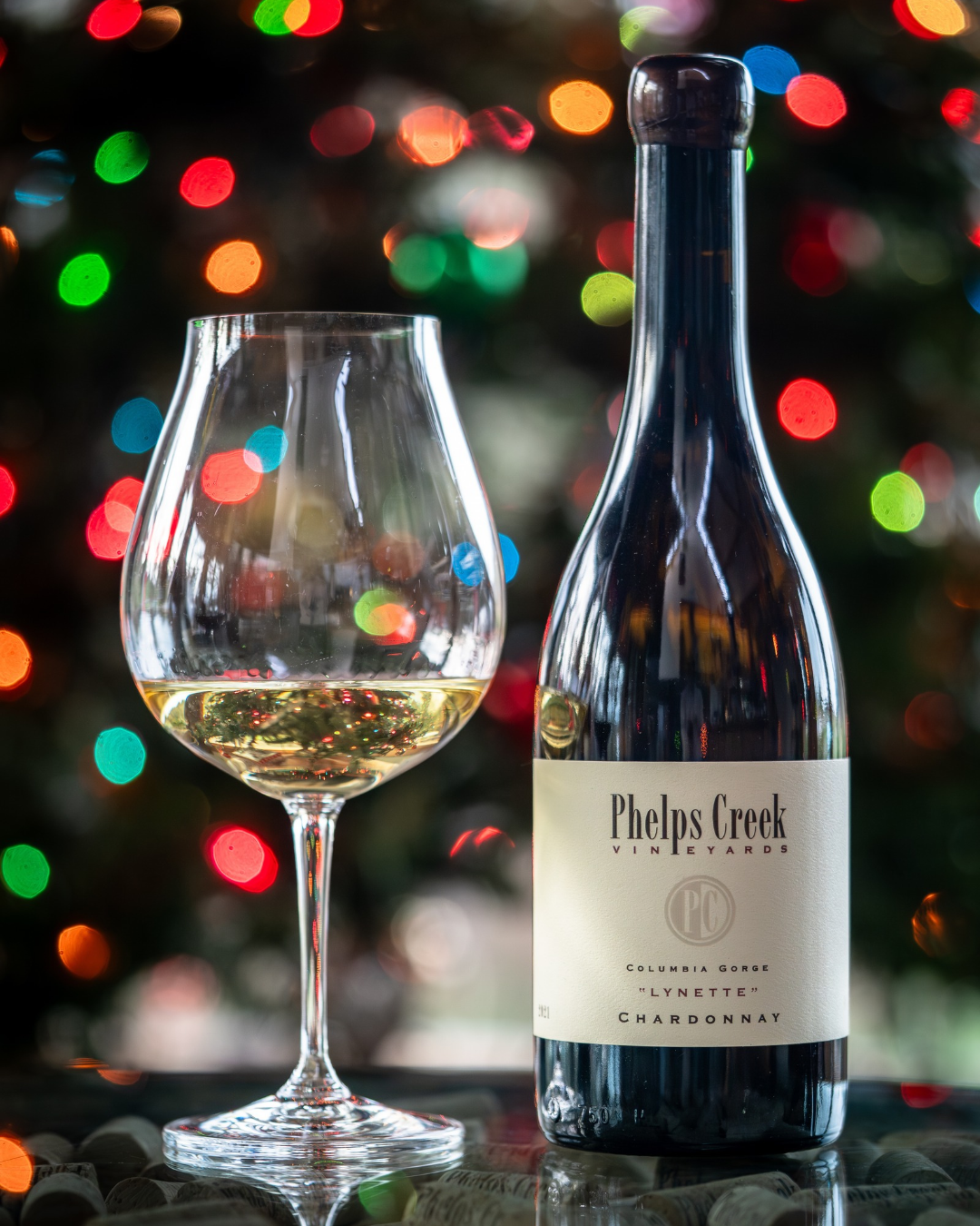 Bottle of Phelps Creek "Lynette" Chardonnay and a glass poured