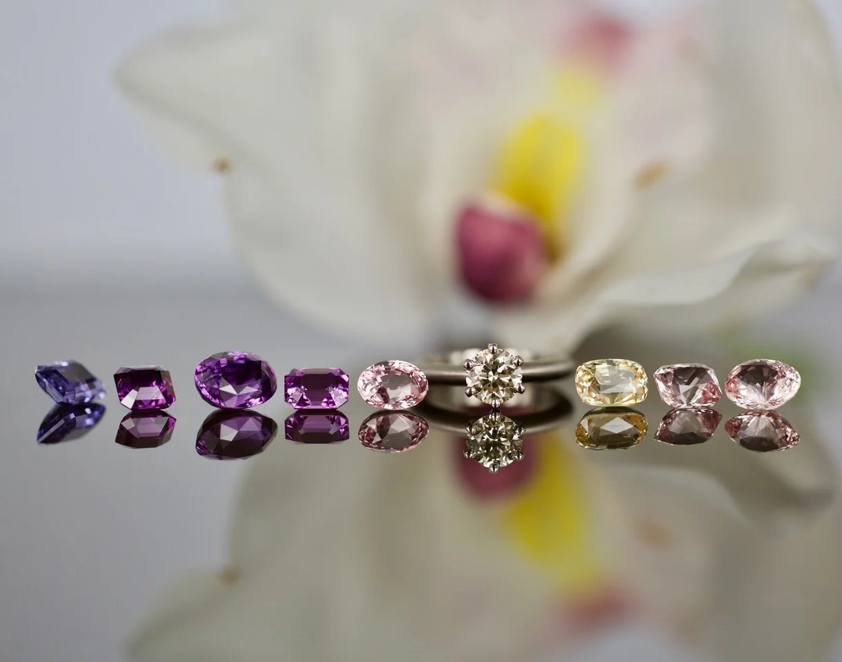 Sapphire comes in a stunning range of colours. Here, purple through to pink and yellow sapphires; with a champagne diamond ring. Image: Tallulah