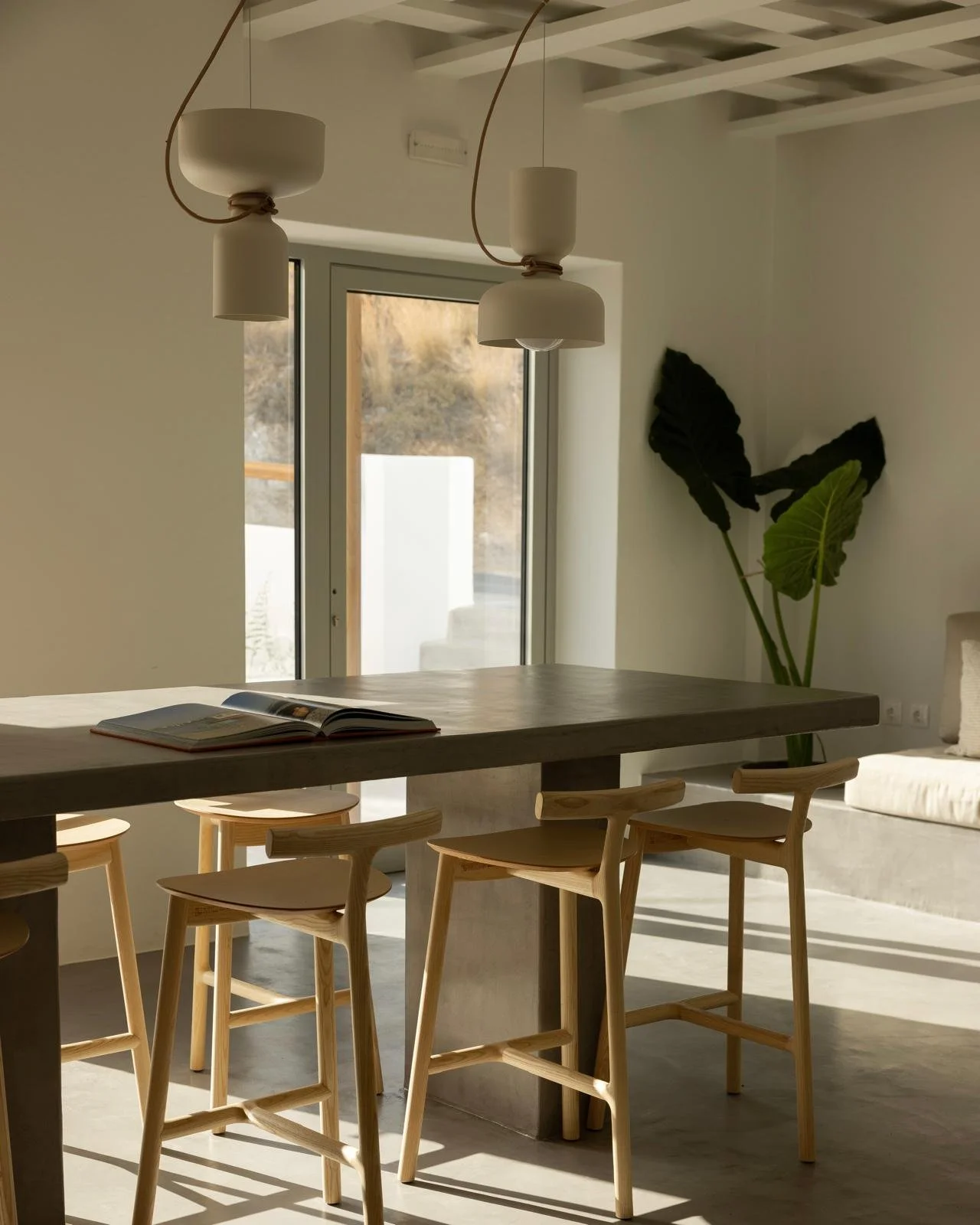 minimalist hotel dining room with concrete and oak furniture