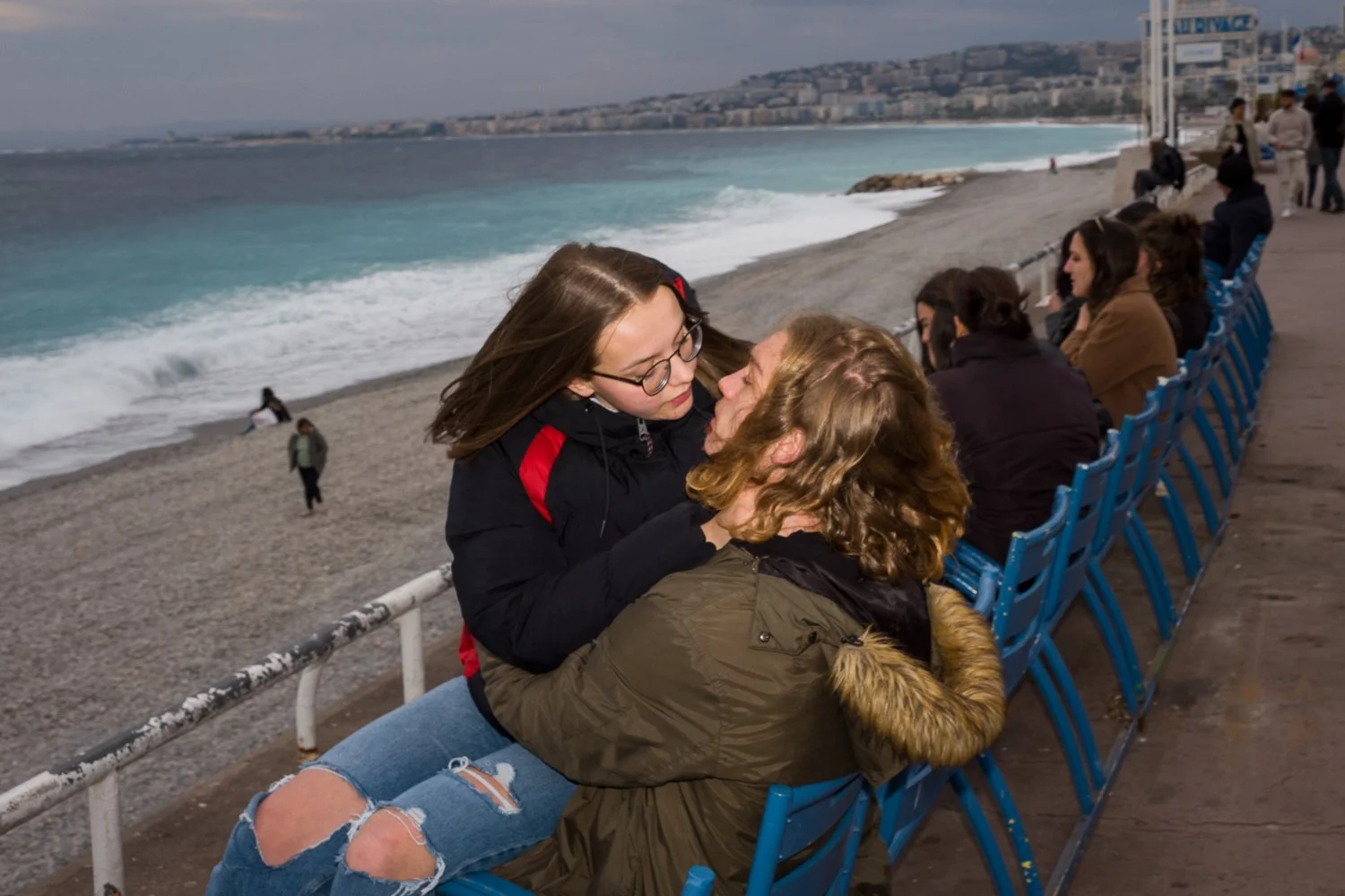 A kiss on a moody windy and grey sky in Nice Promenade des Anglais