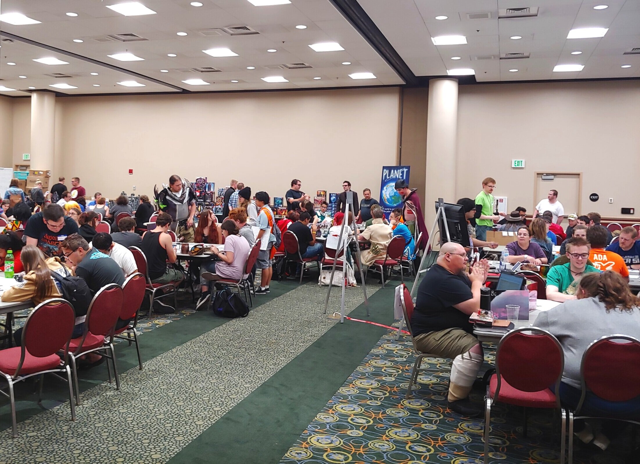 Different angle of large crowd playing tabletop games at FanX