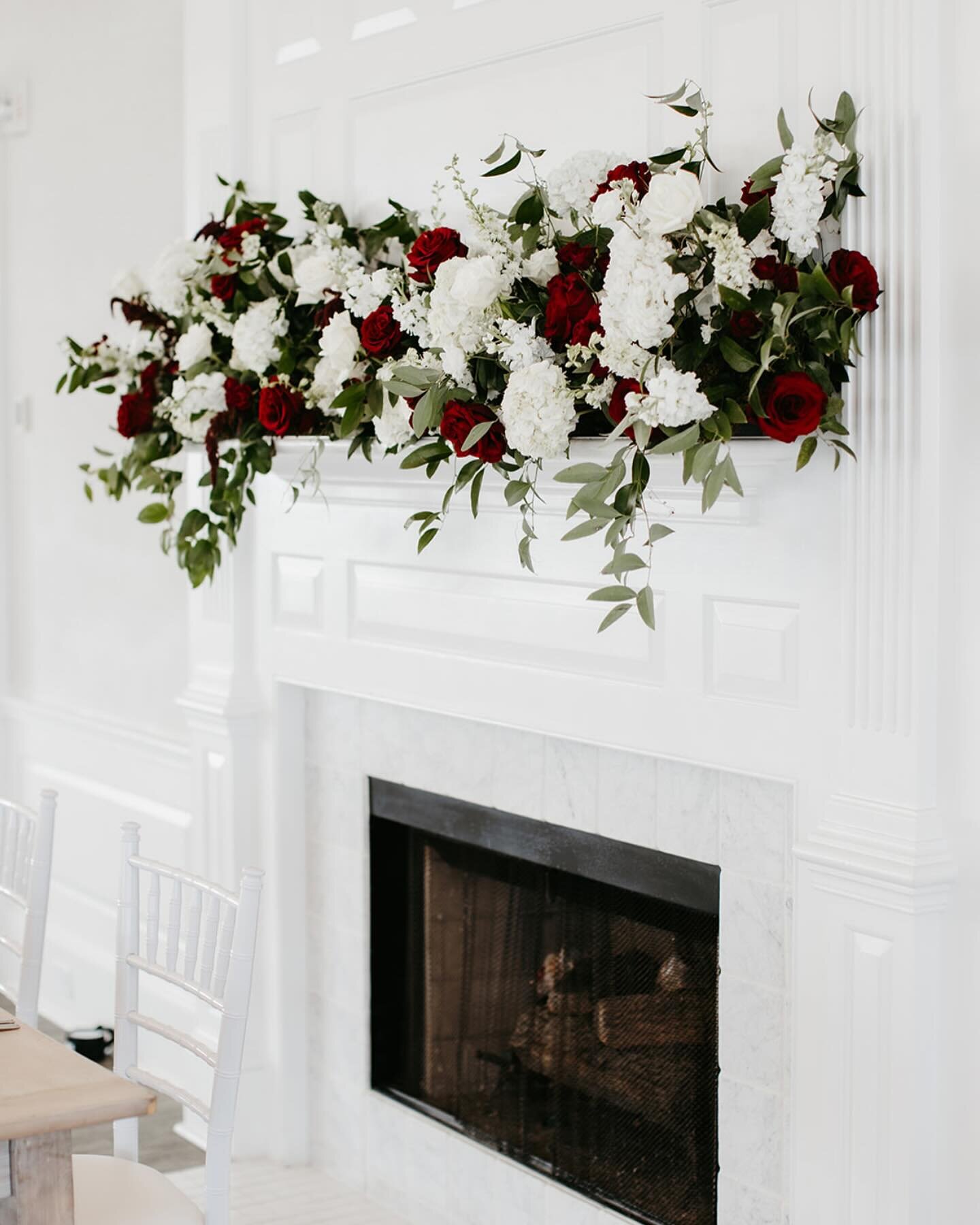I love designing floral arrangements for mantles, it makes such a statement each and every time. 

This mantle piece was mostly white to match the neutral aesthetic of the reception space with pops of red to complement our Bride and Grooms wedding co